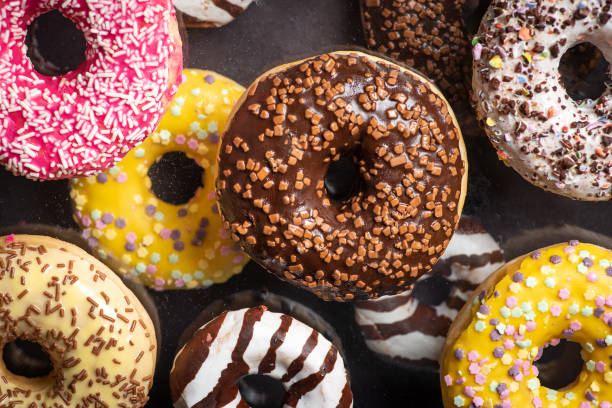 delicious chocolate donuts from LoveWithDonut. The donuts feature various toppings and fillings, including chocolate glaze, sprinkles, and chocolate fillings, all crafted with high-quality ingredients for a decadent treat.